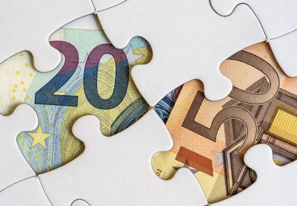 Jigsaw pieces with euro banknotes