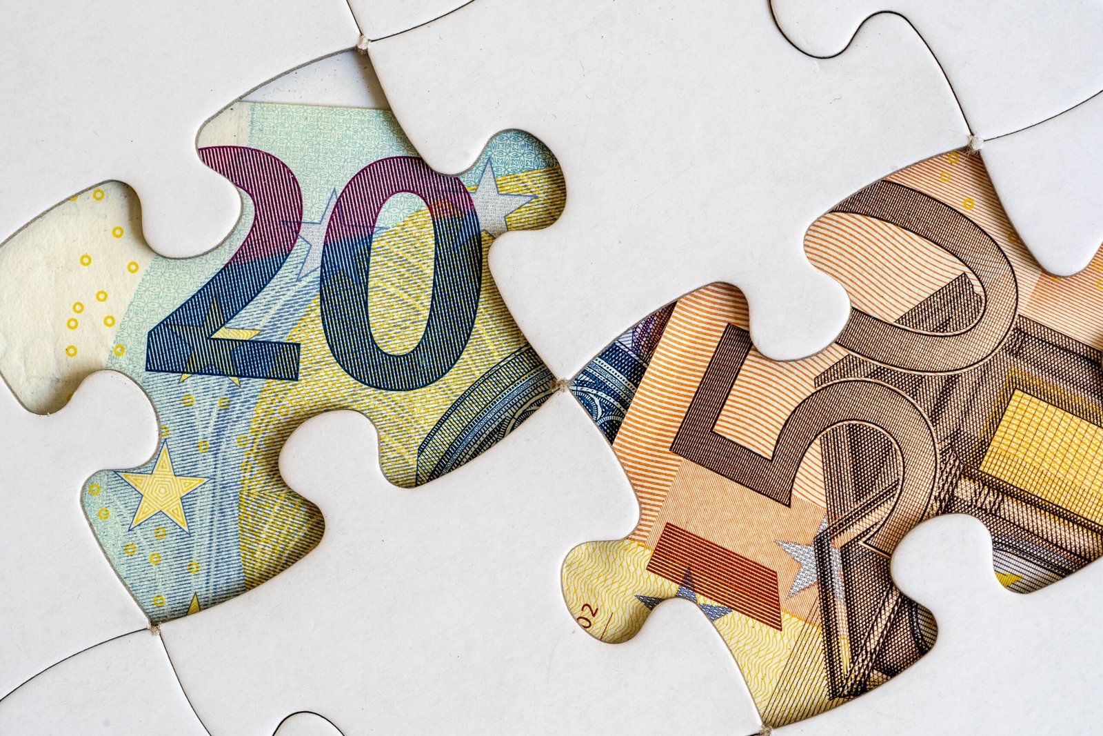 Jigsaw pieces with euro banknotes